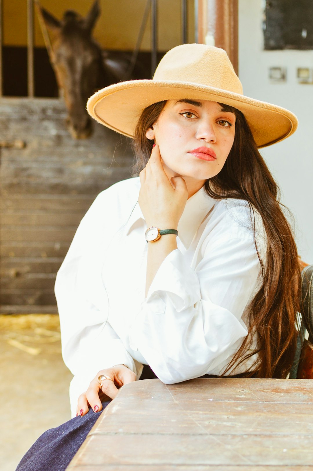 Photo by Chermiti Mohamed Woman wears a hat and looks at the camera.